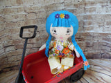 Lollipop Girl, White, Blue Braids, Orange/Purple/Yellow Floral Top/Light Yellow Pants
